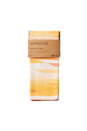 Front facing packaging image of yellow, salmon, white and gold eco-friendly tribal pattern towel. Available for purchase on The Conservationist.